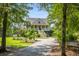 Charming two-story home with a welcoming front porch and landscaped front yard at 8964 Palmetto Rd, Edisto Island, SC 29438