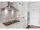 Bright kitchen featuring granite countertops, stainless steel appliances, and white cabinetry at 8964 Palmetto Rd, Edisto Island, SC 29438