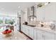 Bright, white kitchen with stainless steel appliances, granite countertops, and eat-in island at 8964 Palmetto Rd, Edisto Island, SC 29438