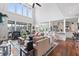 Bright open-concept living room with soaring ceilings, fireplace, and a view of the sunroom and kitchen at 8964 Palmetto Rd, Edisto Island, SC 29438