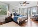 Luxurious main bedroom featuring a king-sized bed, hardwood floors, and serene water views at 8964 Palmetto Rd, Edisto Island, SC 29438