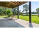Outdoor porch features a swing and offers views of the lush green lawn and waterfront at 8964 Palmetto Rd, Edisto Island, SC 29438