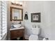 Stylish powder room with a vessel sink, elegant mirror, and modern fixtures at 8964 Palmetto Rd, Edisto Island, SC 29438