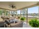 Relaxing screened porch with comfortable seating and a view of the water at 8964 Palmetto Rd, Edisto Island, SC 29438