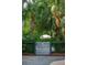 Backyard gate with palm trees and view of outdoor umbrella near pool at 924 Mciver St, Mount Pleasant, SC 29464