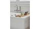 Close up of a luxurious soaking tub with a wooden tray and stylish fixtures at 924 Mciver St, Mount Pleasant, SC 29464