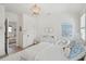 Bright bedroom with white furniture, hardwood floors, and soothing artwork at 924 Mciver St, Mount Pleasant, SC 29464