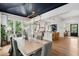 Bright dining room featuring a decorative light fixture, hardwood floors, and views into the kitchen at 924 Mciver St, Mount Pleasant, SC 29464