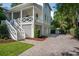 Elegant home exterior featuring white siding, welcoming front porch, and a paved driveway at 924 Mciver St, Mount Pleasant, SC 29464