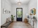 Inviting foyer with hardwood floors, stylish decor, and a black front door at 924 Mciver St, Mount Pleasant, SC 29464