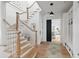 Welcoming foyer with hardwood floors, white staircase, and convenient built-in storage at 924 Mciver St, Mount Pleasant, SC 29464