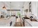 Elegant kitchen with island, marble counters, stainless steel appliances and open to dining area at 924 Mciver St, Mount Pleasant, SC 29464
