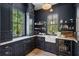Stylish kitchen with dark cabinets, open shelves and views from the window at 924 Mciver St, Mount Pleasant, SC 29464