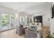 Bright living room with white ceiling beams, light wood floors, and french doors leading to an outdoor patio at 924 Mciver St, Mount Pleasant, SC 29464