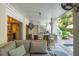 Inviting covered outdoor kitchen with bar seating, poolside access, and comfortable lounge area at 924 Mciver St, Mount Pleasant, SC 29464