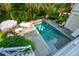 Aerial view of a backyard pool surrounded by lush greenery and lounge chairs at 924 Mciver St, Mount Pleasant, SC 29464