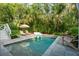 Relaxing pool area featuring lush greenery, comfortable lounge chairs, and a serene backyard oasis at 924 Mciver St, Mount Pleasant, SC 29464