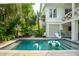 Sparkling pool surrounded by lush tropical foliage with patio seating and lounge chairs for relaxation at 924 Mciver St, Mount Pleasant, SC 29464