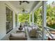 Relaxing porch with ceiling fans, comfortable seating, and an outdoor grill at 924 Mciver St, Mount Pleasant, SC 29464