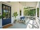 Inviting front porch with a porch swing, blue pillows, and a stylish front door at 924 Mciver St, Mount Pleasant, SC 29464