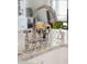 Close up of a polished chrome kitchen sink faucet set on a light marble countertop at 924 Mciver St, Mount Pleasant, SC 29464