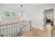 Well-lit upstairs landing featuring a decorative pendant light and staircase railing at 924 Mciver St, Mount Pleasant, SC 29464