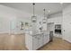 Modern kitchen featuring a large island, white cabinets, stainless steel appliances, and an open layout at 100 E Carolina Ave, Summerville, SC 29483