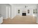 Bright, open-concept living room featuring a fireplace, large windows, and modern finishes at 100 E Carolina Ave, Summerville, SC 29483