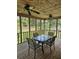 Enclosed back porch featuring a wood ceiling, ceiling fans, screens, and an outdoor dining set at 101 Brittany Ct, Summerville, SC 29485