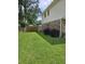 Lush backyard with green grass and a wooden fence, offering privacy and space at 101 Brittany Ct, Summerville, SC 29485