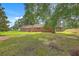 View of the back exterior with a relaxing porch and lots of yard for outdoor activities at 1023 Striper Ave, Moncks Corner, SC 29461