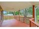 A covered back porch overlooks the lush greenery of the spacious backyard at 1023 Striper Ave, Moncks Corner, SC 29461