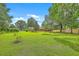 Expansive backyard with mature trees providing shade, offering ample space at 1023 Striper Ave, Moncks Corner, SC 29461