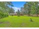 Expansive backyard surrounded by mature trees, offering privacy and ample space at 1023 Striper Ave, Moncks Corner, SC 29461