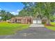 Charming brick home with well-manicured lawn and a convenient attached three-car garage at 1023 Striper Ave, Moncks Corner, SC 29461