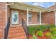 Inviting front porch with brick steps and railing leading to a classic front door at 1023 Striper Ave, Moncks Corner, SC 29461