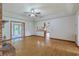 Bright and airy living room with fireplace, wood floors, and multiple entryways to kitchen and deck at 1023 Striper Ave, Moncks Corner, SC 29461