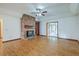 Spacious living room featuring hardwood floors and a charming brick fireplace at 1023 Striper Ave, Moncks Corner, SC 29461