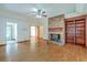 Spacious living room with hardwood floors, brick fireplace, ceiling fan, and large built in shelves at 1023 Striper Ave, Moncks Corner, SC 29461