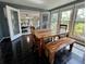 Bright dining area features a wooden table and bench, with large windows offering plenty of natural light at 1039 Grand Concourse St, Charleston, SC 29412