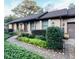 Charming brick home with meticulously landscaped front yard, winding walkway, and lush greenery at 1039 Grand Concourse St, Charleston, SC 29412