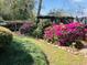 Picturesque garden with colorful azaleas, a wooden arbor, and lush green lawn at 1039 Grand Concourse St, Charleston, SC 29412