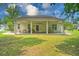 Rear exterior featuring a covered patio, ceiling fans, and a well-maintained lawn at 107 Oakbluff Rd, Summerville, SC 29485