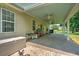 Covered back patio equipped with grill and ceiling fan, creating an ideal space for outdoor cooking and dining at 107 Oakbluff Rd, Summerville, SC 29485
