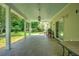 Spacious covered back porch with tiled flooring, ceiling fans, and views of the backyard at 107 Oakbluff Rd, Summerville, SC 29485