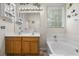 Bathroom showcasing double sinks, a large mirror, and a soaking tub by a window at 107 Oakbluff Rd, Summerville, SC 29485