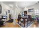 A formal dining room features hardwood floors, a chandelier, and a dining table set for a meal at 107 Oakbluff Rd, Summerville, SC 29485