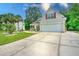 Inviting home exterior features a two-car garage, well-maintained lawn, and attractive landscaping at 107 Oakbluff Rd, Summerville, SC 29485