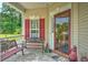 Charming front porch with bench seating and decorative plants, providing a welcoming entrance to the home at 107 Oakbluff Rd, Summerville, SC 29485