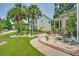 Charming home exterior featuring a well-manicured lawn and lush landscaping with palm trees and decorative elements at 107 Oakbluff Rd, Summerville, SC 29485